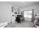 Cozy bedroom with neutral carpet, bright window, and a wall adorned with an array of diplomas at 105 Smoky Emerald Way, Holly Springs, NC 27540