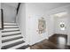 Bright foyer with wooden stairs, hardwood floors, and stylish decor that create a welcoming atmosphere at 105 Smoky Emerald Way, Holly Springs, NC 27540