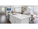 Open-concept kitchen with a large island, stainless steel appliances, and a view into the living and dining spaces at 105 Smoky Emerald Way, Holly Springs, NC 27540