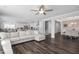 Bright and open living space with hardwood floors, a sectional sofa, and an open layout into the dining and kitchen areas at 105 Smoky Emerald Way, Holly Springs, NC 27540