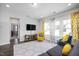 Living room with modern furniture, a decorative rug, and plenty of natural light from large windows at 105 Smoky Emerald Way, Holly Springs, NC 27540