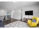 Bright and open living room featuring hardwood floors and comfortable seating with view of stairs at 105 Smoky Emerald Way, Holly Springs, NC 27540