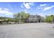 Community pool and amenity center with outdoor seating, a pergola, and a well-maintained parking area at 105 Smoky Emerald Way, Holly Springs, NC 27540