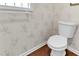 Cozy half bathroom with patterned wallpaper and a white toilet at 1054 Weathervane Hill Dr, Rocky Mount, NC 27803