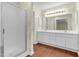 Bathroom featuring double sink vanity with white cabinets, wood floor and walk-in shower at 1054 Weathervane Hill Dr, Rocky Mount, NC 27803