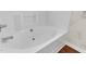 Bright white bathroom with tiled walls and a clean, deep soaking tub at 1054 Weathervane Hill Dr, Rocky Mount, NC 27803