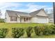 Attractive single-story house with a two-car garage, tidy lawn, and tasteful landscaping at 1054 Weathervane Hill Dr, Rocky Mount, NC 27803