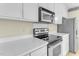 Close-up of kitchen with sleek appliances, white countertops, and ample counter space at 1054 Weathervane Hill Dr, Rocky Mount, NC 27803