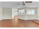 Open living room with hardwood floors, with views to entryway and kitchen at 1054 Weathervane Hill Dr, Rocky Mount, NC 27803