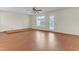 Open living room with wood-look flooring, ceiling fan, and access to patio at 1054 Weathervane Hill Dr, Rocky Mount, NC 27803
