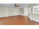 Living room with wood-look floors, ceiling fan, and views into kitchen at 1054 Weathervane Hill Dr, Rocky Mount, NC 27803