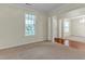 Sunlit living area showcases transition between hardwood floors to carpet; airy and connected at 1054 Weathervane Hill Dr, Rocky Mount, NC 27803