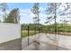 View of the patio with a backyard view framed by lush greenery and a treeline in the distance at 1054 Weathervane Hill Dr, Rocky Mount, NC 27803