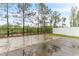 Backyard patio area featuring a black metal fence and a treeline in the distance at 1054 Weathervane Hill Dr, Rocky Mount, NC 27803
