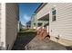 This backyard features a patio, grass, wooden staircase, and fencing at 109 Broadwater Dr, Wake Forest, NC 27587