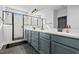 Bathroom featuring double vanity, quartz countertop, modern faucets, black fixtures, and glass-enclosed shower at 109 Broadwater Dr, Wake Forest, NC 27587