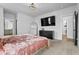 Bright bedroom featuring plush carpet, a modern bedframe, stylish curtains and a large mirror at 109 Broadwater Dr, Wake Forest, NC 27587