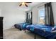 Bright bedroom with large windows, comfortable beds, and a ceiling fan with light at 109 Broadwater Dr, Wake Forest, NC 27587