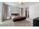Bright bedroom featuring plush carpet, a modern bedframe, stylish curtains and an elegant ceiling light fixture at 109 Broadwater Dr, Wake Forest, NC 27587