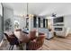 Open dining room with decorative lighting adjacent to a cozy living area with fireplace at 109 Broadwater Dr, Wake Forest, NC 27587