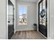 Bright foyer with hardwood floors, a stylish front door, and a view to the outside at 109 Broadwater Dr, Wake Forest, NC 27587