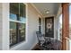 Charming front porch featuring a wooden rocking chair, decorative wreath, and cozy outdoor ambiance at 109 Broadwater Dr, Wake Forest, NC 27587