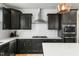 Close-up of a modern kitchen with stainless steel appliances, white countertops, and sleek cabinets at 109 Broadwater Dr, Wake Forest, NC 27587