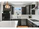Well-appointed kitchen with modern stainless steel appliances, subway tile backsplash and black cabinetry at 109 Broadwater Dr, Wake Forest, NC 27587