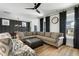 Spacious living room with a large sectional sofa, hardwood floors, and a modern dining area at 109 Broadwater Dr, Wake Forest, NC 27587