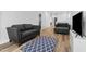 Cozy living room featuring hardwood floors, comfortable seating and a patterned area rug at 109 Broadwater Dr, Wake Forest, NC 27587
