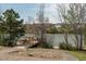 Scenic pond view with a gazebo extending over the water, framed by trees and neighborhood homes at 109 Broadwater Dr, Wake Forest, NC 27587