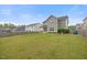 Expansive fenced backyard features green grass, a firepit, and an abundance of room for entertainment at 109 Oak Rise Ln, Fuquay Varina, NC 27526