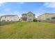 Spacious, fenced backyard featuring lush green grass, offering ample space for outdoor activities and relaxation at 109 Oak Rise Ln, Fuquay Varina, NC 27526