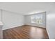 Bedroom featuring wood floors, white trim, and a large window at 109 Oak Rise Ln, Fuquay Varina, NC 27526