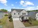 Two-story home with a two-car garage and landscaped front yard under a partly cloudy sky, with lush grass at 109 Oak Rise Ln, Fuquay Varina, NC 27526