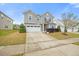 A home with a two-car garage and green lawn, the home has a well-maintained yard and landscaping at 109 Oak Rise Ln, Fuquay Varina, NC 27526