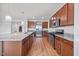 View of kitchen featuring granite counters, stainless appliances, dark cabinetry and wood-look flooring at 109 Oak Rise Ln, Fuquay Varina, NC 27526