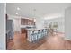 Open kitchen featuring stainless steel appliances, dark wood cabinetry, and a large granite island with bar stool seating at 109 Oak Rise Ln, Fuquay Varina, NC 27526