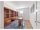 Functional home office featuring custom built-in shelving, a spacious desk, and bright natural light at 109 Oak Rise Ln, Fuquay Varina, NC 27526