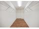 Large walk-in closet with hardwood floors and ample shelving for organization at 109 Oak Rise Ln, Fuquay Varina, NC 27526