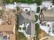 Home aerial showcases snow-dusted roof, private backyard, and inviting outdoor deck area, nestled in mature landscaping at 109 Yorkchester Way, Raleigh, NC 27615