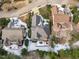 Aerial view of the home featuring a snow-dusted roof, manicured lawn, patio, and lush landscaping at 109 Yorkchester Way, Raleigh, NC 27615