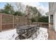 Outdoor deck with dining set, an umbrella, and a decorative privacy lattice at 109 Yorkchester Way, Raleigh, NC 27615