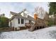 Charming home exterior featuring a wooden deck, brick chimney, and snow-covered yard for winter enjoyment at 109 Yorkchester Way, Raleigh, NC 27615