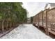 Backyard with a wooden fence, mature trees, snow covered ground, and a wooden deck at 109 Yorkchester Way, Raleigh, NC 27615