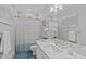 Bright bathroom featuring stylish blue tile floors, vanity, and framed mirror at 109 Yorkchester Way, Raleigh, NC 27615