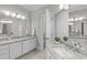 Bright bathroom with granite countertops, double sinks, and white cabinets at 109 Yorkchester Way, Raleigh, NC 27615