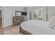 Cozy bedroom with a wooden dresser, television, and sunny bay window at 109 Yorkchester Way, Raleigh, NC 27615
