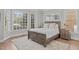 Charming bedroom featuring a bay window, wood-frame bed, and plush rug at 109 Yorkchester Way, Raleigh, NC 27615