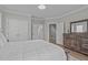 Bright bedroom showcasing crown molding, double closets, and a wooden dresser at 109 Yorkchester Way, Raleigh, NC 27615